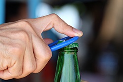 Opening a bottle with a bottle opener