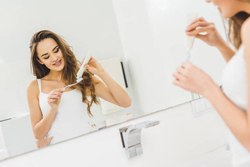 woman brushing teeth