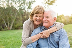 older couple smiling outside