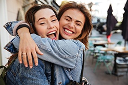 Patient in Plano smiling with friend after getting a tooth-colored filling
