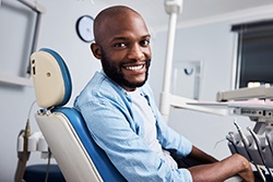 Bearded man visiting dentist for full mouth reconstruction in Plano, TX