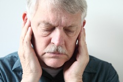 Man touching his TMJ on both sides 