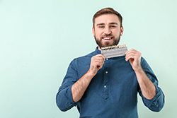 a man showing off his veneers in Plano