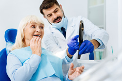 a dental patient smiling while chatting with her dentist