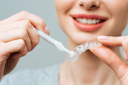 a patient preparing a whitening tray