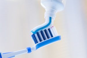 toothpaste squeezed on toothbrush
