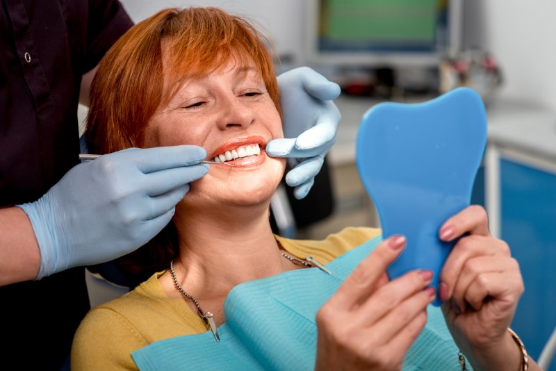 Woman smiling with dental implants in Plano