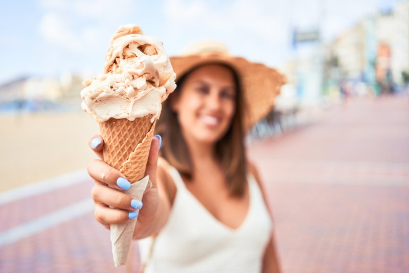 woman holding up ice cream cone