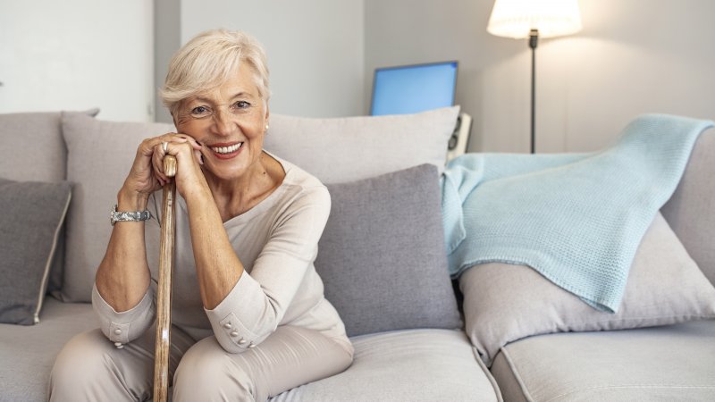 woman smiling and adjusting to implant dentures in Plano