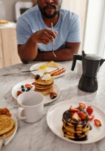 Man eating breakfast foods