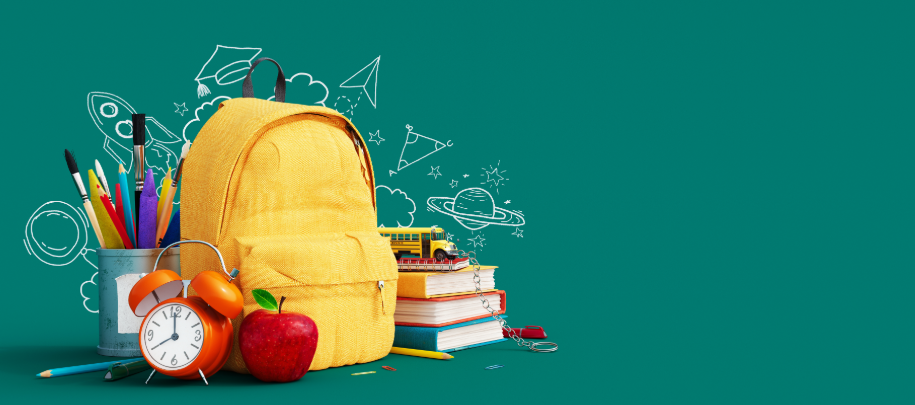 Yellow backpack with school supplies on green background