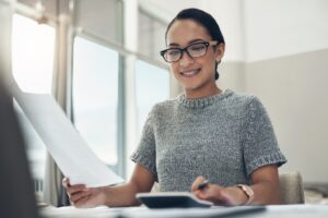 Adult woman wearing braces at work desk.